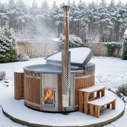 Outdoor winter setting of premium sand filter wood fired hot tub with integrated stove, wooden steps, and snow-covered cover open