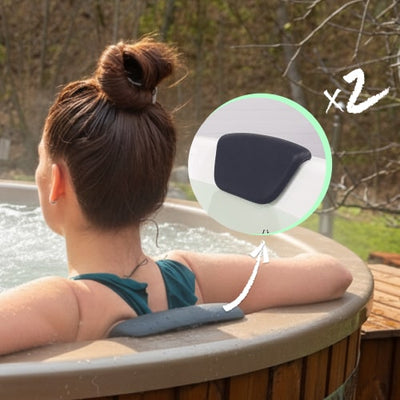 Rear view of woman relaxing in wood fired hot tub with dark headrests installed along the edge outdoors