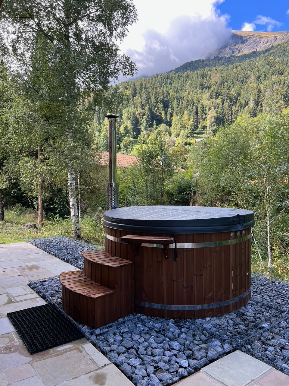 Gardenvity hot tub in German backyard with mountain view.