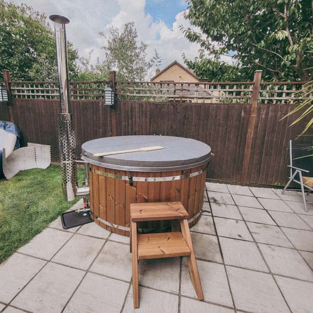 Customer's photo with a quality wood-fired hot tub from Gardenvity