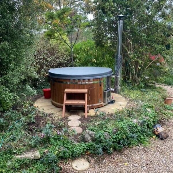 Customer's photo with a Gardenvity wood-fired hot tub surrounded by nature