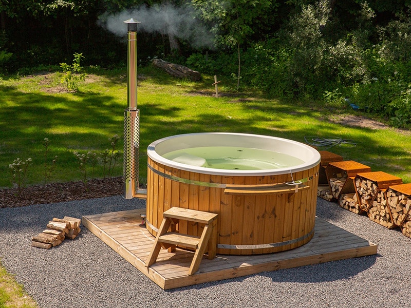 A Gardenvity hot tub installed on a gravel base and prepared for bathing.
