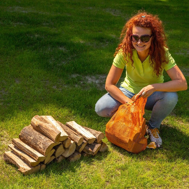 Milda getting the firewood needed to heat the water in her hot tub.