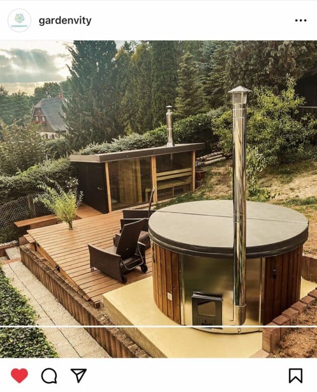 A Gardenvity wood-fired hot tub in a customer's cosy environment surrounded by trees