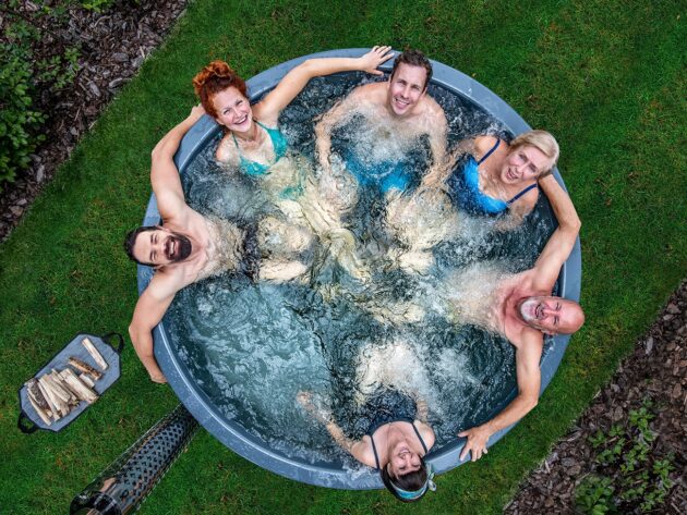 6 people relaxing in a Gardenvity wood-fired hot tub