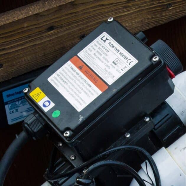 The black electric 3 kW heater of the wood-fired hot tub